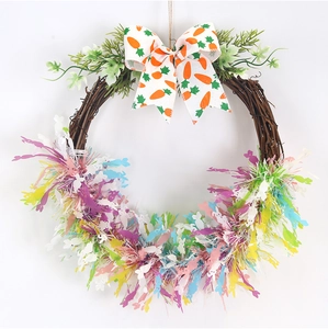 Detail of Easter wreath with carrot bow, green leaves and colorful bunny silhouettes