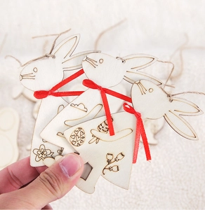 Close-up of Easter wooden bunny tag with laser-engraved flower patterns and red bow