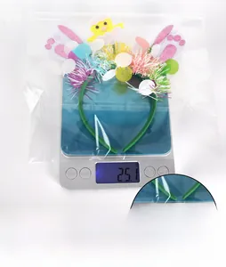Detail eines Oster-Haarreifs mit Küken und Hasenohren auf einer Waage mit 25,1g Gewicht