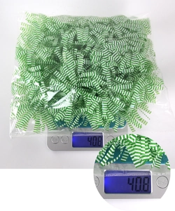 Detail of 40g green and white shredded paper filler on scale for Easter gift packaging