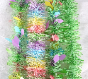 Close-up of vibrant Easter party tinsel garlands with colorful sequins on white faux fur