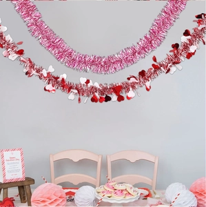 Detail of red and pink heart-shaped tinsel garlands for Valentine's Day party decoration