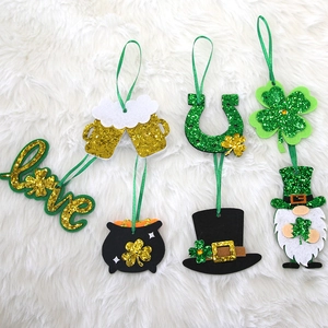 St. Patrick's Day glitter clover and gnome hanging ornaments set on white fur background