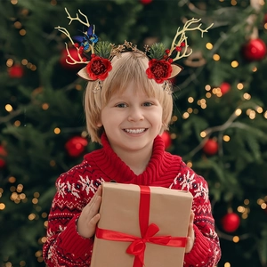 Christmas reindeer antler headband with festive berries and golden branches on a young girl