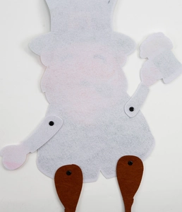 Macro detail of felt gnome pendant with articulated limbs for St. Patrick's Day decor