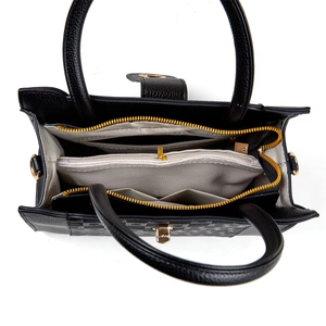 Top view of black pebbled leather tote interior with gold zipper and gray chevron lining