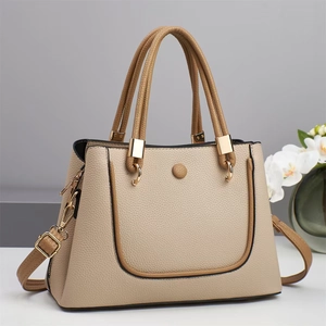 Elegant two-tone beige and brown pebbled leather handbag with gold hardware and shoulder strap