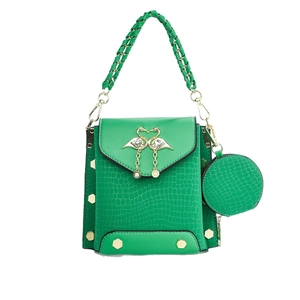 Green faux crocodile leather handbag with flamingo heart buckle and braided handle