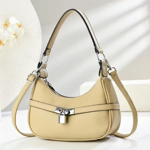 Detail of lychee pattern leather underarm bag with silver decorative padlock closure