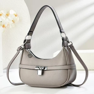 Detail of grey lychee leather hobo bag with iconic silver padlock on white geometric background
