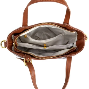 Top view of spacious handbag interior with grey chevron lining and gold-tone zippers