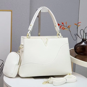 Détail du sac cabas blanc grainé avec fermoir en V doré et petit porte-monnaie rond
