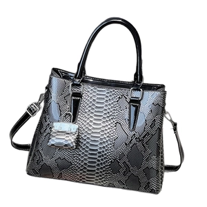 Fashionable black and grey python print tote bag with glossy handles and mini charm
