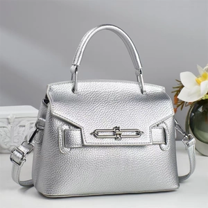 Close-up of silver pebble leather handbag with premium metallic twist lock detail