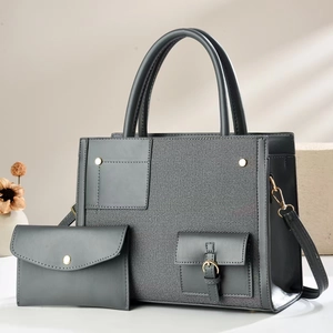 Close-up of grey patchwork tote bag with matching pouch and gold hardware details
