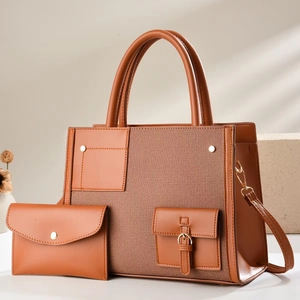 Detail of caramel leather and woven fabric tote bag with matching pouch and metal buckle
