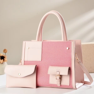 Detail of pink two-piece set featuring a tote bag and pouch with mixed leather texture