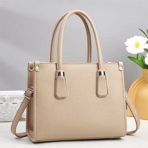 Detail view of beige lychee texture leather handbag with silver hardware and tulip decor