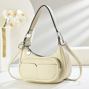 Detail of cream white grained leather crescent bag with silver zippers and pockets