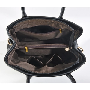 Internal view of the large capacity shoulder bag showing multiple zipper compartments