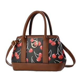 Vintage cherry print tote bag with brown faux leather handles and gold metal logo