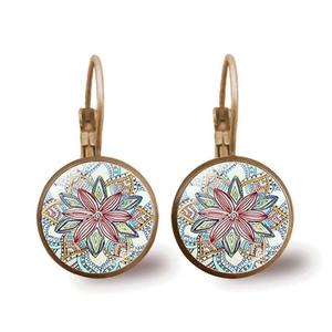 Detailed close-up of vintage bronze mandala earrings with vibrant glass cabochon artwork