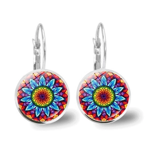 Detailed macro view of vintage mandala pattern earrings with round glass cabochon