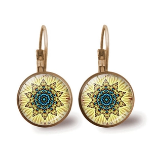 Detailed macro view of lever-back earrings with vintage bronze mandala glass pendants
