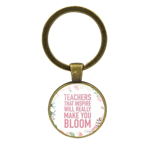 Detail of vintage bronze teacher gift keychain with floral quote charm on white background