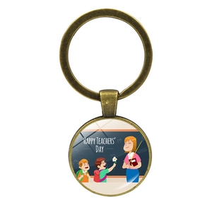 Detail of bronze teacher gift keychain featuring a happy teachers day glass cabochon