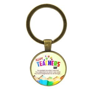 Detailed macro view of bronze Happy Teachers Day keychain with pencil and balloon motifs