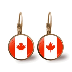 Detailed close-up of bronze Canada flag earrings with red maple leaf and glass dome