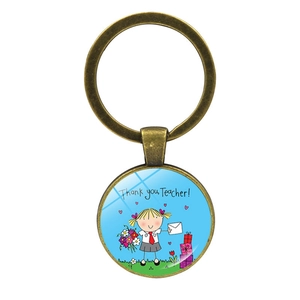 Macro detail of bronze teacher gift keychain with 'Thank you, Teacher!' glass dome art