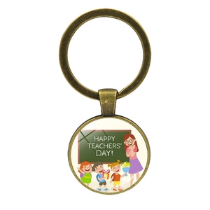 Detailed view of bronze teacher appreciation keychain with Happy Teachers Day glass dome