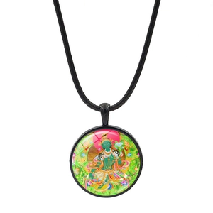 Close-up of Hindu Durga glass cabochon pendant on black rope chain necklace