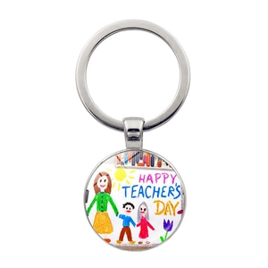 Detail of silver Teacher's Day keychain showing happy teacher and students illustration