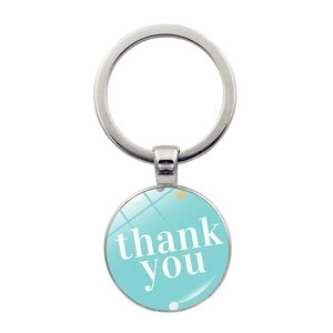 Detailed view of silver teacher gift keychain with glass cabochon and thank you text