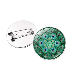 Detailed view of mandala glass cabochon brooch with peacock feather pattern and back pin