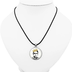 Ruth Bader Ginsburg necklace with silver pendant on white jewelry bust display