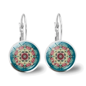 Detailed close-up of mandala glass cabochon earrings with silver lever-back hooks