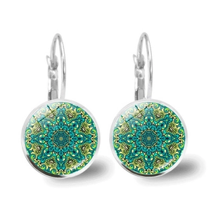 Macro detail of silver mandala earrings featuring cyan and yellow geometric glass domes