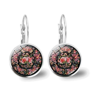 Detail view of Mandala floral pattern glass cabochon in leverback earring setting