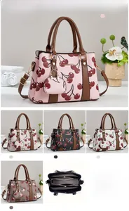 Detail view of large capacity faux leather handbag set with cherry print and inner lining