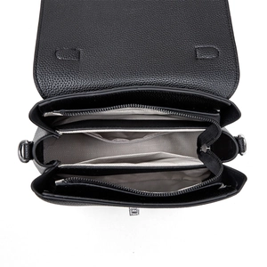 Internal view of black leather bag showing multi-compartments and wave pattern lining