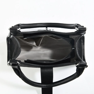 Vue intérieure d'un sac à main en cuir noir avec doublure chevron et poches multiples