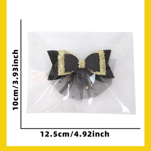 Detail of 2026 black and gold New Year hair clip with mesh veil and star print