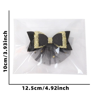 Black and gold New Year bow hair clip with mesh star detail and size measurements