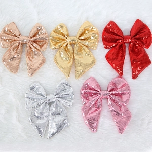 Set di cinque grandi fiocchi natalizi con paillettes oro, rosso e argento su ecopelliccia