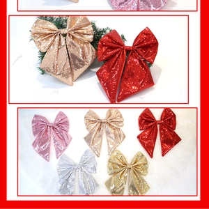 Dettaglio di fiocchi glitterati per albero di Natale in rosso, oro, argento, rosa e cipria