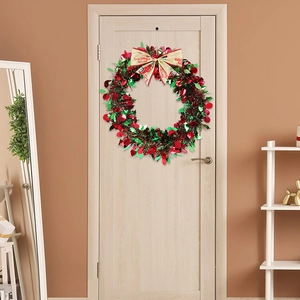 Detail of a festive Christmas wreath with colorful tinsel and a Merry Christmas ribbon bow